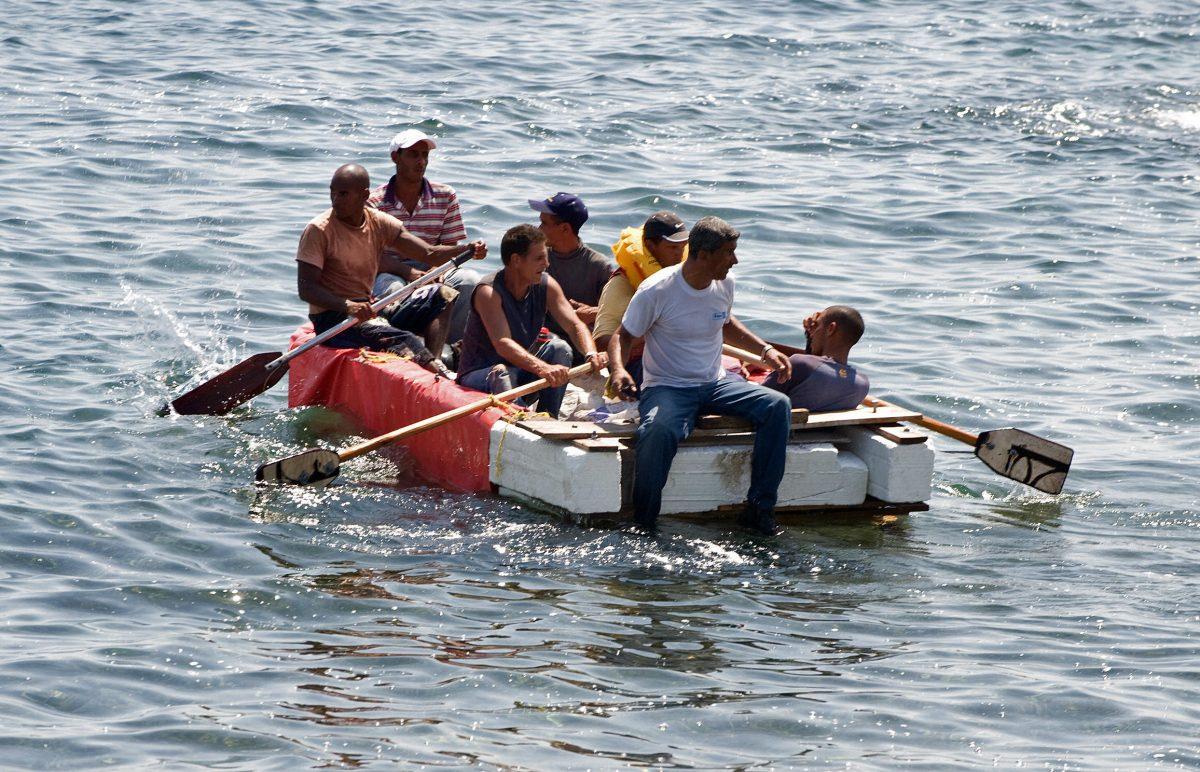 Seven would-be Cuban emigres remain in a homemade boat moments before being arrested by Cuban military agents after their attempt to escape from the island nation was thwarted by the sea currents, on June 4, 2009, in Havana. (Adalberto Roque/AFP/Getty Images)