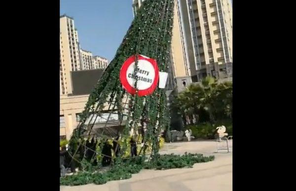 Video footage recently uploaded online appears to show a large Christmas tree in China being toppled by a group of men. The incident is said to have taken place in Beijing. (Screenshot from Weibo video)