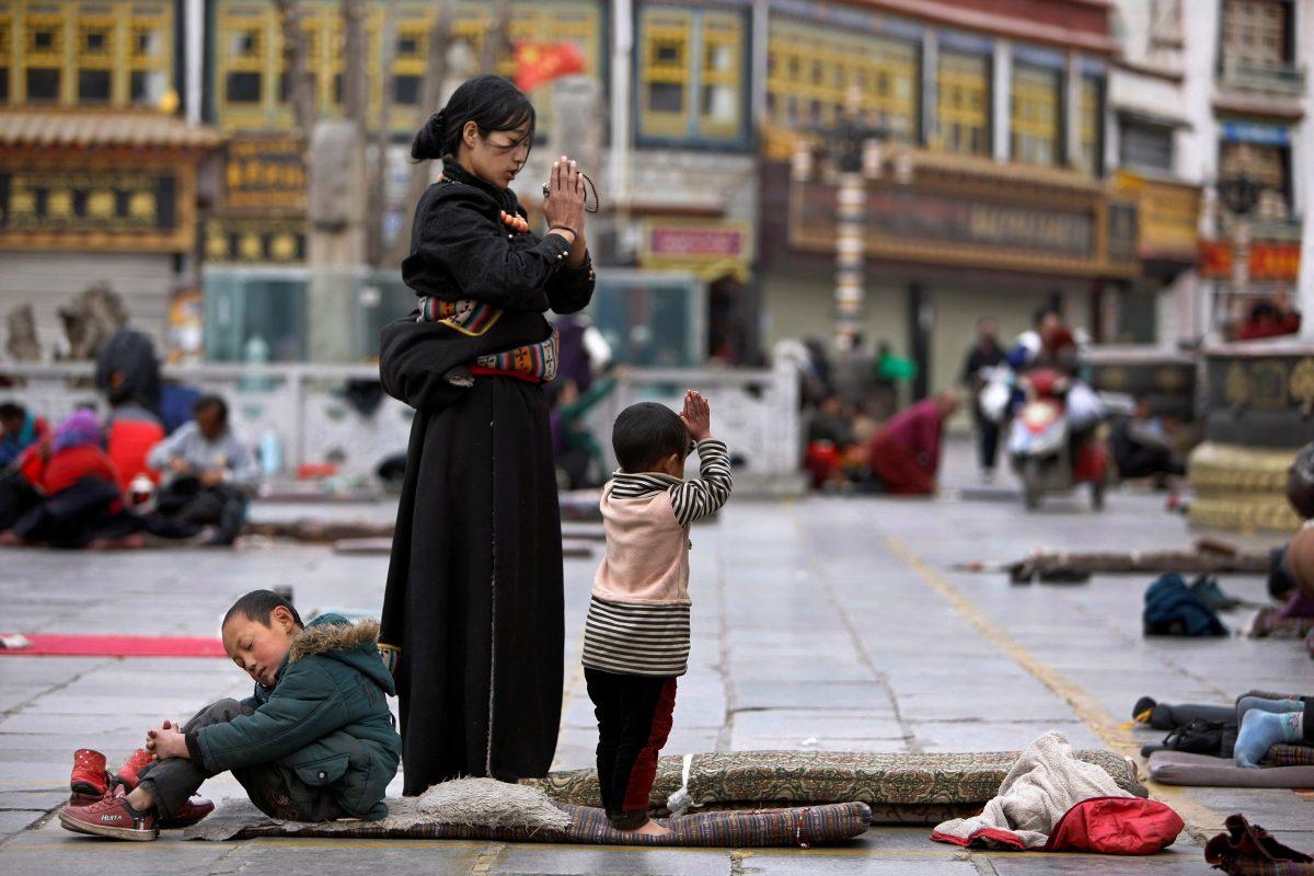 Tibetans pray outside Jokhang Monastery ahead of Tibetan New Year's Day in Lhasa, Tibet on February 28, 2014. (Jacky Chen/File Photo/Reuters)