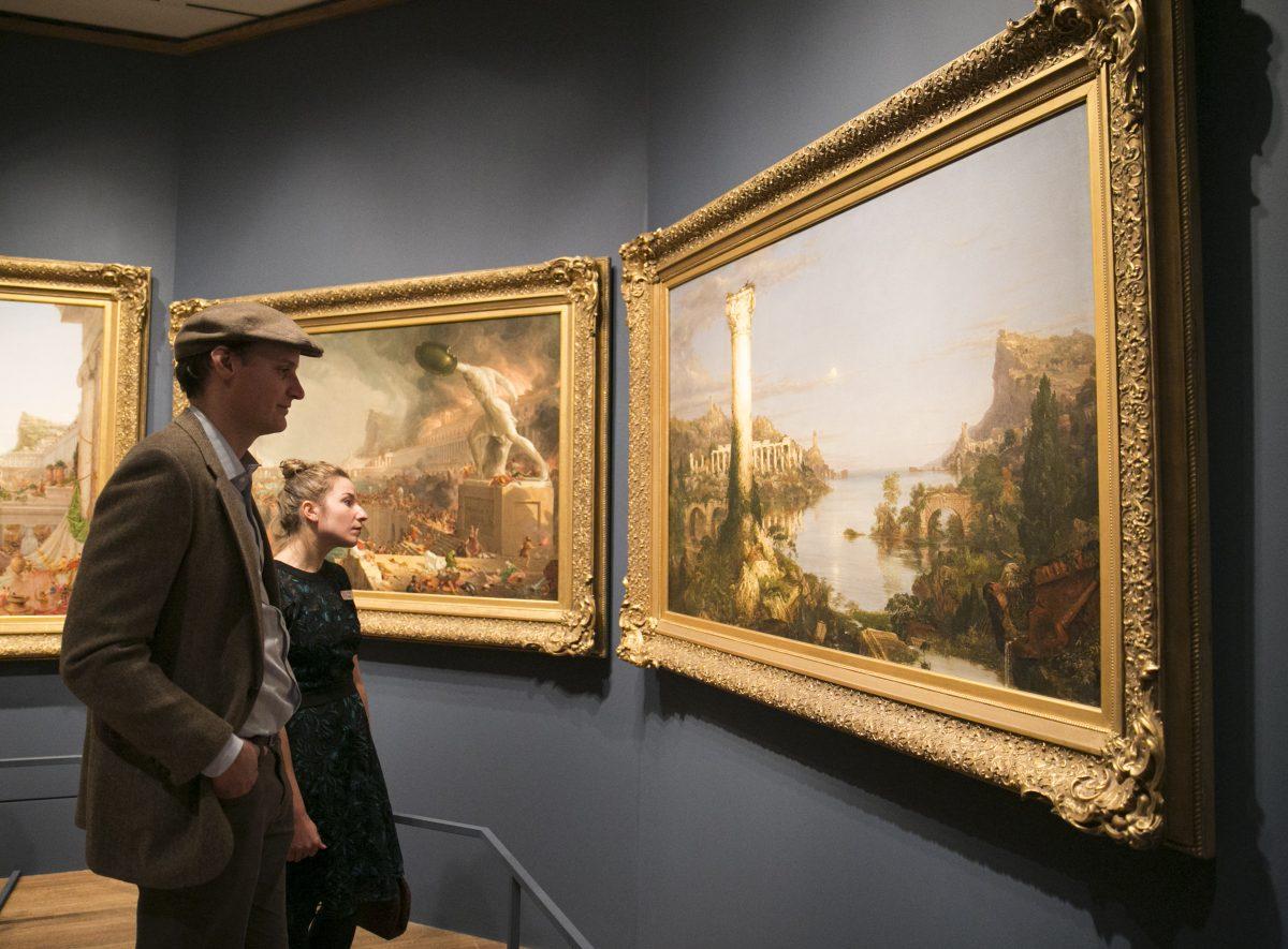 Landscape painters Lauren Sansaricq and Erik Koeppel look at Thomas Cole's series, "The Course of Empire," at The Metropolitan Museum of Art in New York, on Feb. 26, 2018. (Milene Fernandez/The Epoch Times)