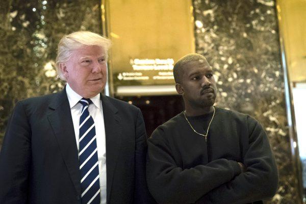 Then-President-elect Donald Trump and Kanye West stand together in the lobby at Trump Tower in New York City on Dec.13, 2016. (Drew Angerer/Getty Images)