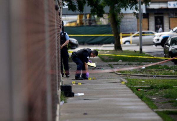 Chicago Police officers and detectives investigate a shooting where multiple people were shot in Chicago, Ill., on Aug. 5, 2018. (Joshua Lott/Getty Images)