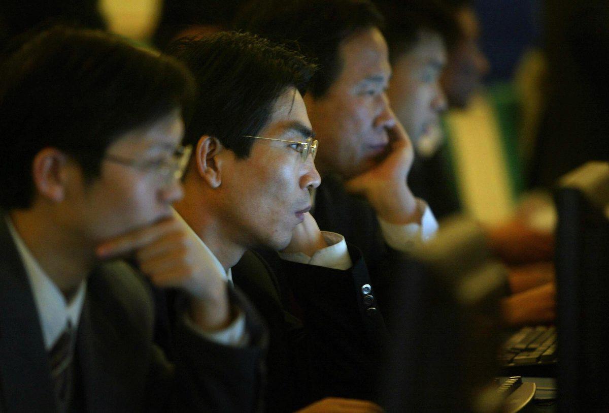 Chinese officials surf the internet in Beijing on March 14, 2004. (Frederic J. Brown/AFP/Getty Images)