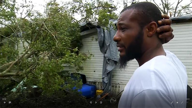 Michael White fights back tears as he surveys the wreckage of his family home. (AP screenshot)