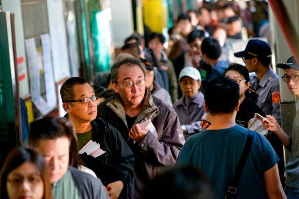 Residents queue outside a polling station at an elementary school to vote in local elections in Taipei on Nov. 24, 2018. (Chris Stowers/AFP/Getty Images)