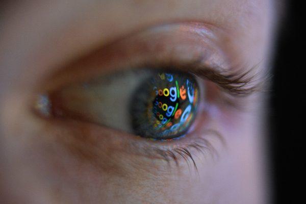 An image of the Google logo is reflected on the eye of a man in London on Aug. 9, 2017. (Leon Neal/Getty Images)