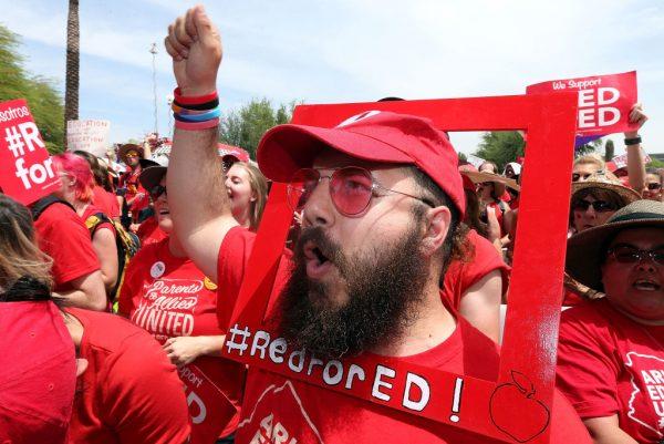 Aude Odeh, an English teacher at Barry Goldwater High School, cheers in support of the #REDforED movement during a rally in front of the State Capitol in Phoenix, Ariz., on April 26, 2018. (Ralph Freso/Getty Images)