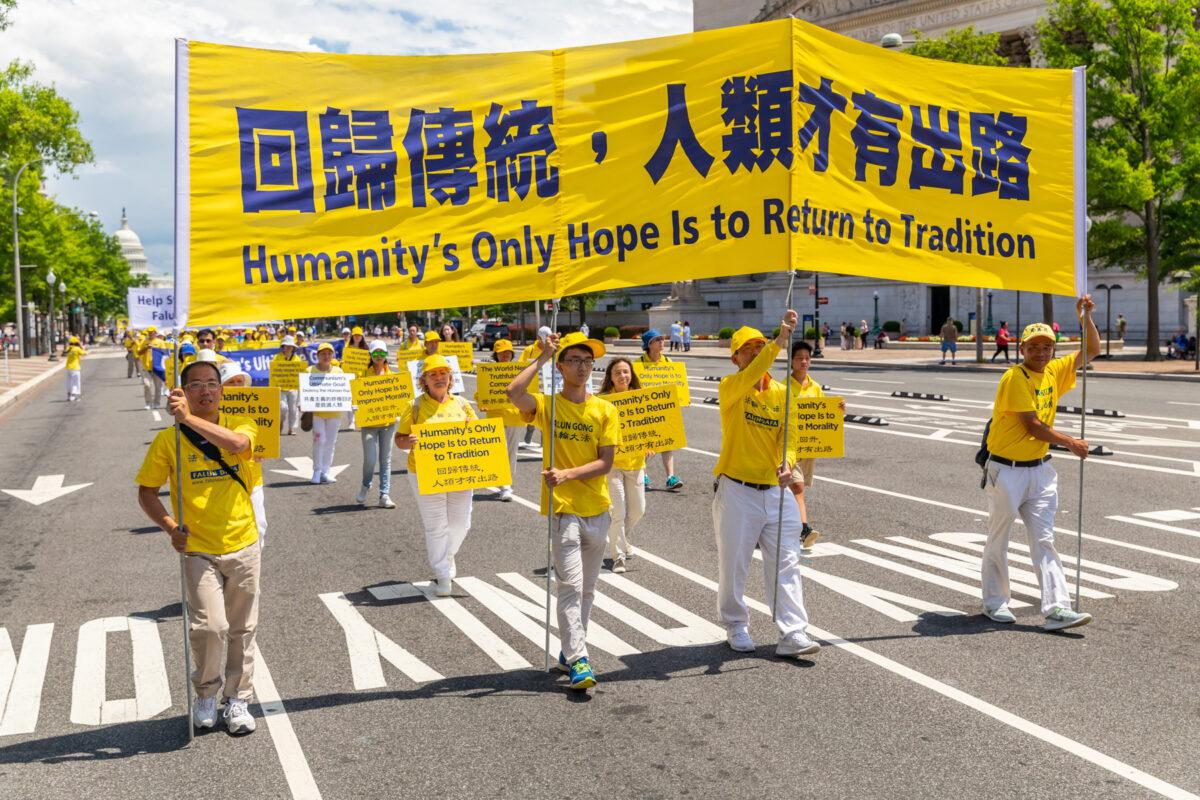 Falun Gong practitioners take part in a parade commemorating the 20th anniversary of the persecution of Falun Gong in China, in Washington, on July 18, 2019. (Mark Zou/The Epoch Times)