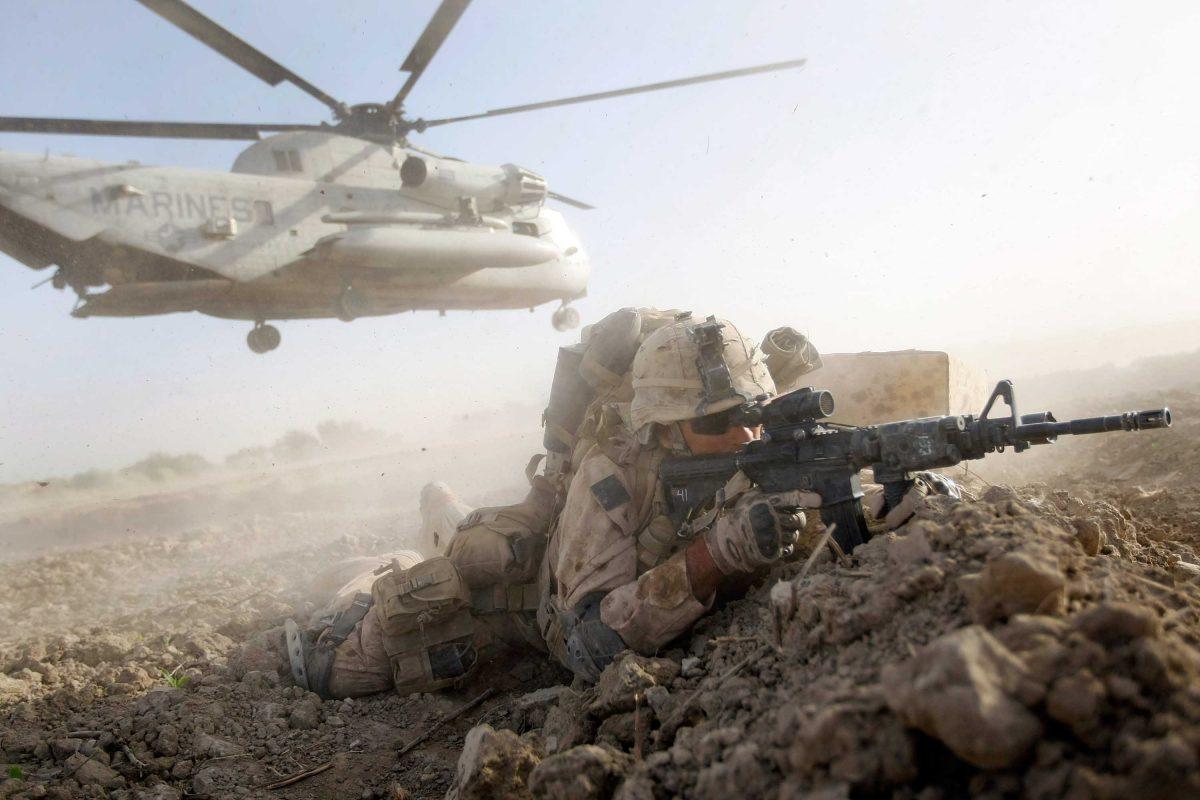 A U.S. Marine from Echo Co., 2nd Battalion, 8th Marines, takes up a fighting position during the start of Operation Khanjari in Main Poshteh, Afghanistan, on July 2, 2009. (Joe Raedle/Getty Images)