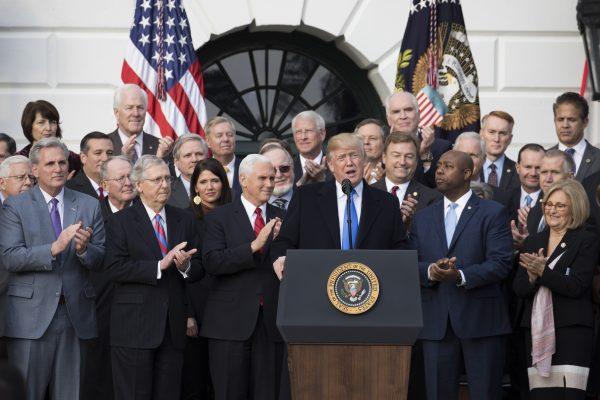 President Donald Trump and members of Congress celebrate the passage of the tax bill on Dec. 20, 2017. (Samira Bouaou/The Epoch Times)