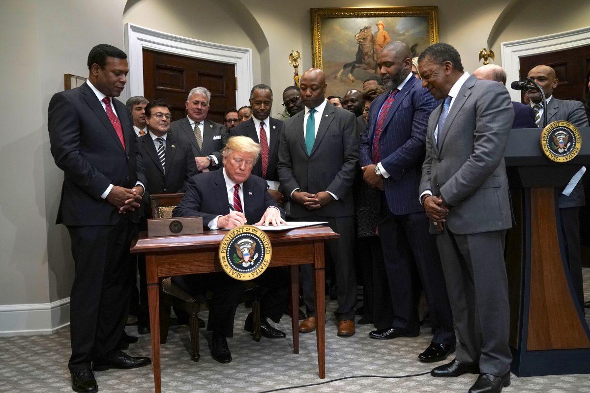 President Donald Trump signs an executive order to establish the White House Opportunity and Revitalization Council on Dec. 12, 2018. (Alex Wong/Getty Images)