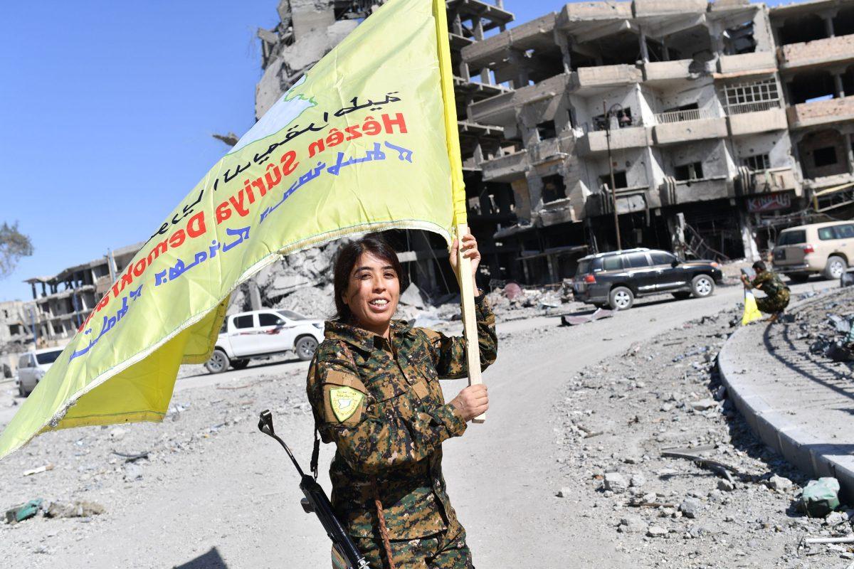 A U.S.-backed Syrian Democratic Forces commander celebrates after they expelled the ISIS terrorist group from the northern Syrian city Raqqa on Oct. 17, 2017. (BULENT KILIC/AFP/Getty Images)