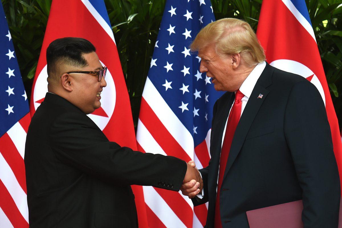 President Donald Trump shakes hands with North Korea's leader Kim Jong Un after a signing ceremony at the end of their U.S.–North Korea summit on Sentosa Island, Singapore, on June 12, 2018. (ANTHONY WALLACE/AFP/Getty Images)