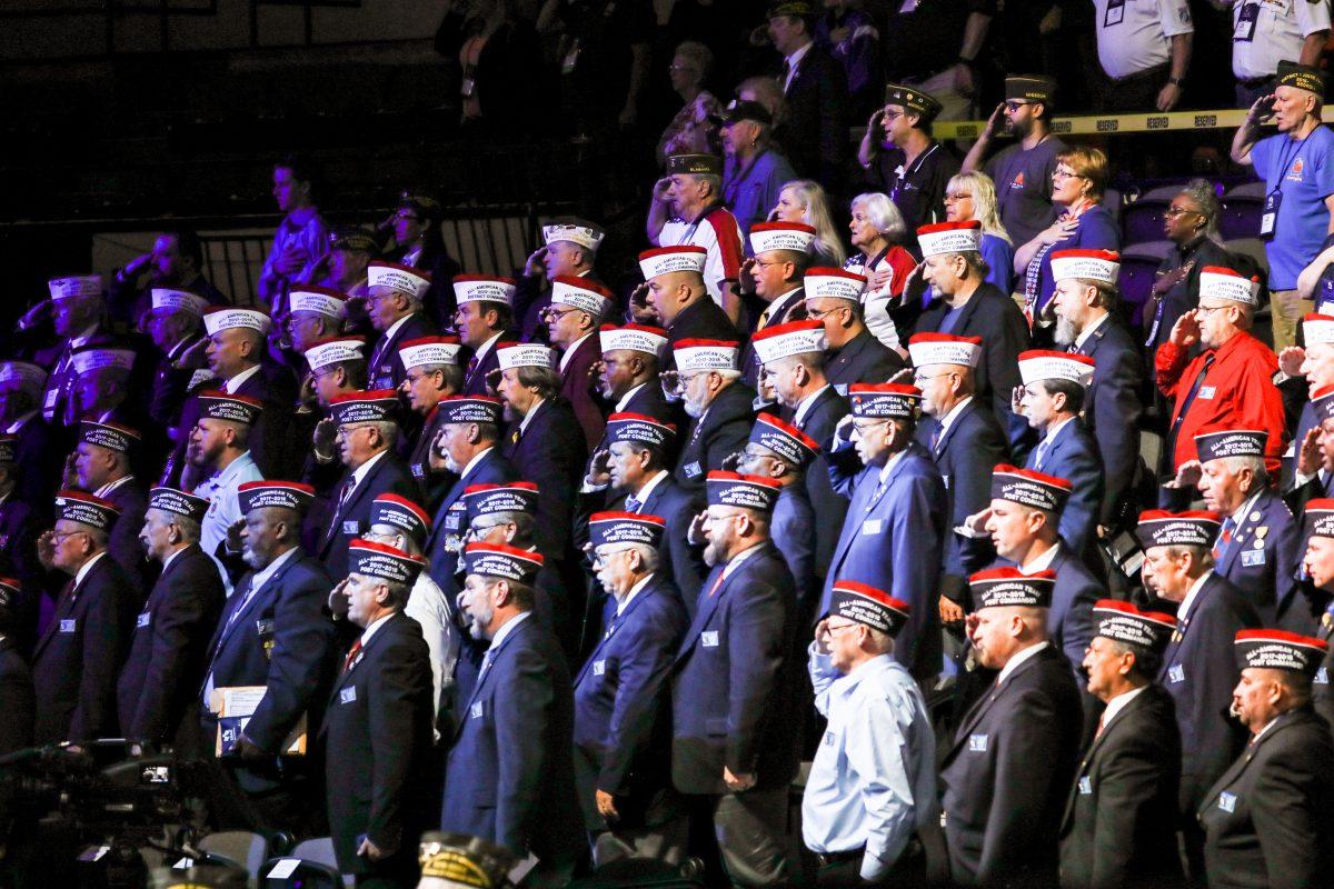 Veterans stand for the opening prayer at the 119th annual Veterans of Foreign Wars Conference in Kansas City, Mo., on July 24, 2018. (Charlotte Cuthbertson/The Epoch Times)