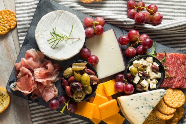 Gourmet Fancy Charcuterie Board with Meat Cheese and Grapes. (Shutterstock)