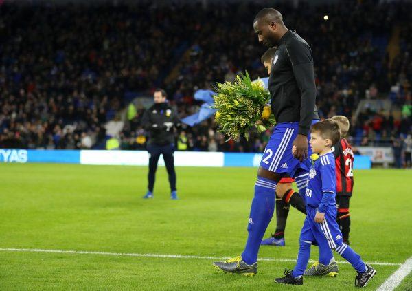 Sol Bamba of Cardiff City leads the team out with a bouquet of flowers as a memorial to Emiliano Sala before a match at Cardiff City Stadium on Feb. 2, 2019. (Warren Little/Getty Images)