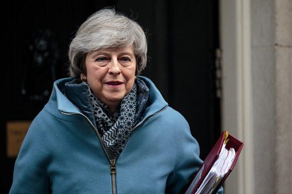 Then British Prime Minister Theresa May leaves Number 10 Downing Street for Prime Minister's Questions in Parliament in London on Feb. 13, 2019. (Jack Taylor/Getty Images)