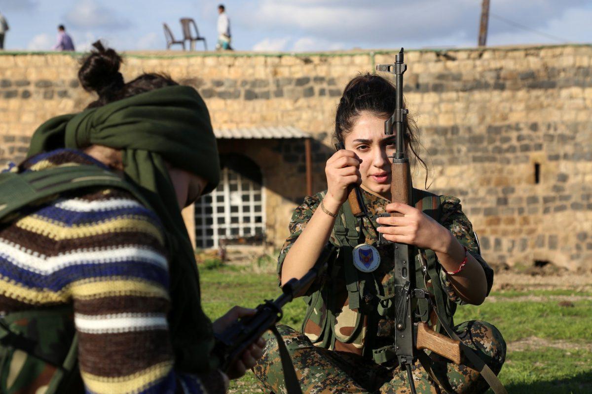 A member of the Kurdish battalion called the "Female Protection Forces of the Land Between the Two Rivers”—allied against ISIS—loads her weapon in al-Qahtaniyah, near the Syrian-Turkish border, on Dec. 1, 2015. (Delil Souleiman/AFP/Getty Images)