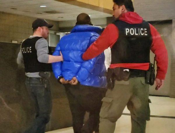 In this still image taken from video, R. Kelly is escorted by police in custody at the Chicago Police Department's Central District on Feb. 22, 2019. (Nader Issa/Chicago Sun-Times via AP)