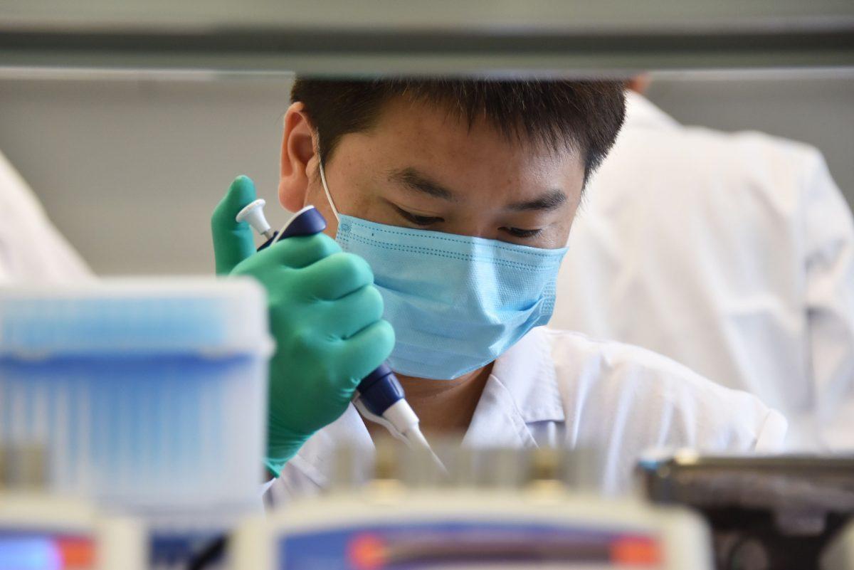 A technician works in a lab specializing in DNA in Beijing on Aug. 22, 2018. (Greg Baker/AFP/Getty Images)