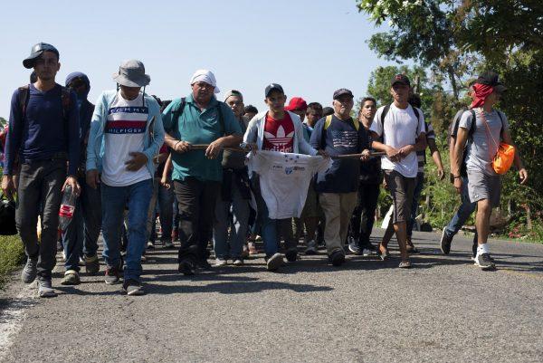 Central American migrants, part of a caravan hoping to reach the U.S. border, walk on a road in Frontera Hidalgo, Mexico, on April 12, 2019. (Isabel Mateos/Photo via AP)