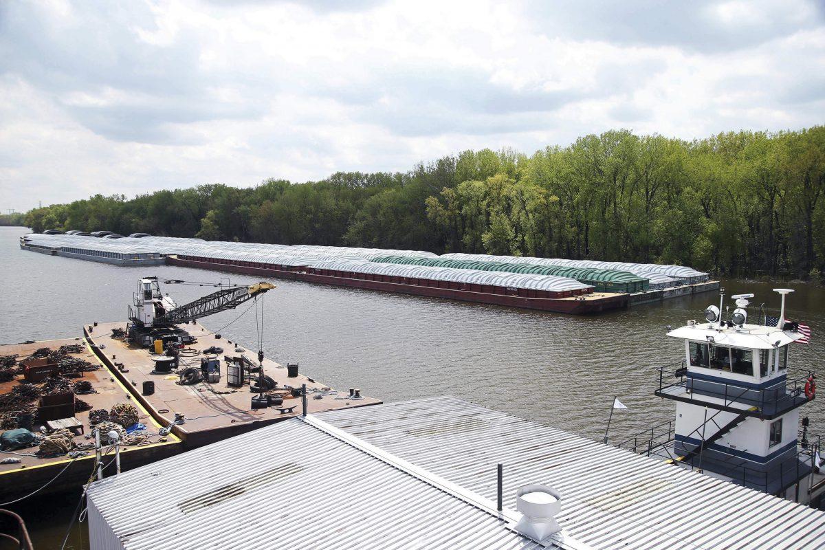 Barges already loaded with soybeans, potash, or scrap steel await movement on the Mississippi River in St. Paul, Minn., (Jim Mone/AP)