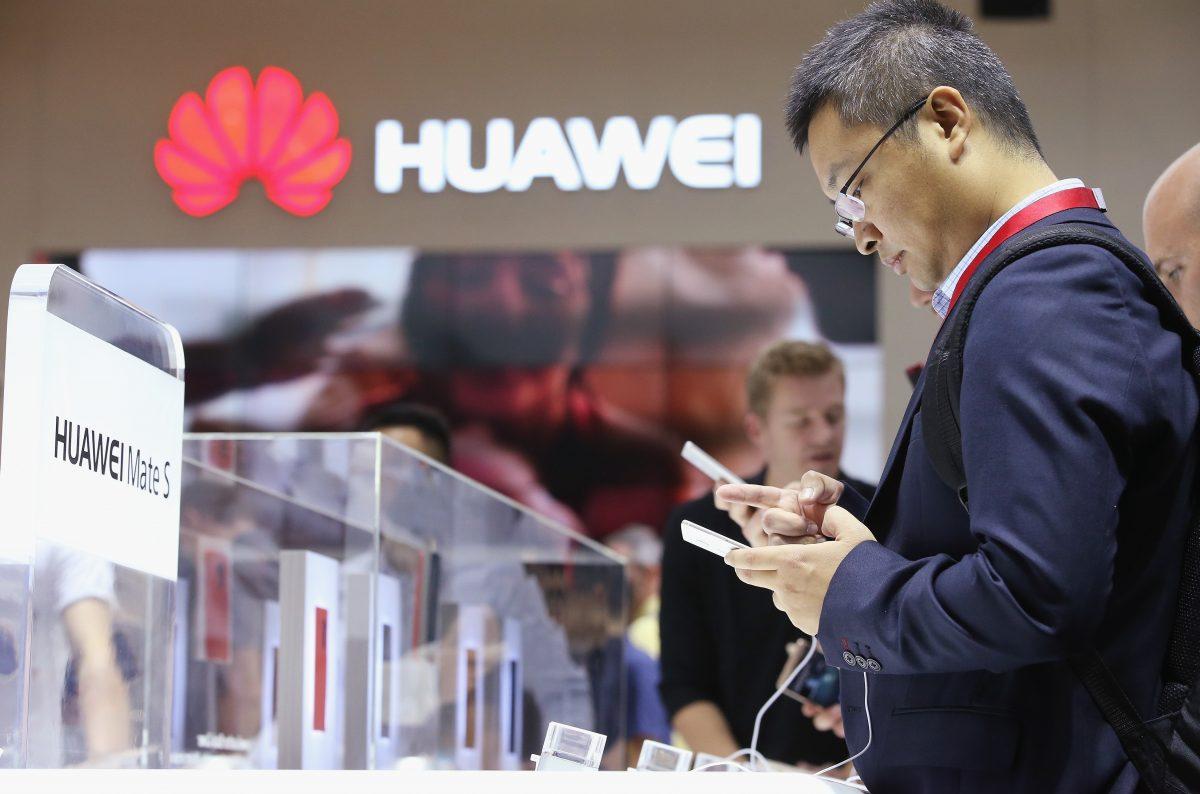 Visitors try out the Huawei Mate S smartphone at the Huawei stand at the 2015 IFA consumer electronics and appliances trade fair in Berlin, Germany, on Sept. 4, 2015 . (Sean Gallup/Getty Images)