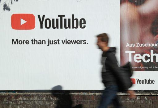 A man walks past a billboard advertisement for YouTube on October 5, 2018, in Berlin. (Sean Gallup/Getty Images)