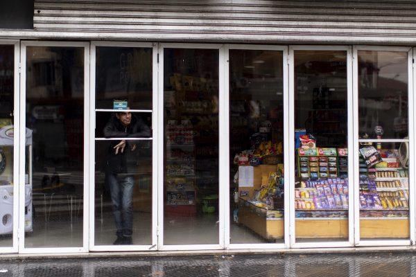 A man stands inside a store without power during the blackout, in Buenos Aires, Argentina, on June. 16, 2019. (AP Photo/Tomas F. Cuesta)