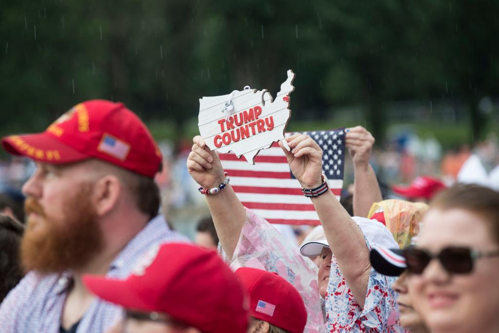 A woman holds a "Trump Country" sign during the opening festivities of President Donald Trump's "Salute to America" ceremony in front of the Lincoln Memorial in Washington on July 4, 2019. (Sarah Silbiger/Getty Images)
