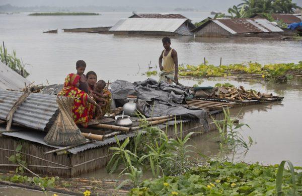 Flood effected villagers move on a makeshift bamboo raft in Katahguri village along the river Brahmaputra, east of Gauhati, India on July 14, 2019. (Anupam Nath/AP)