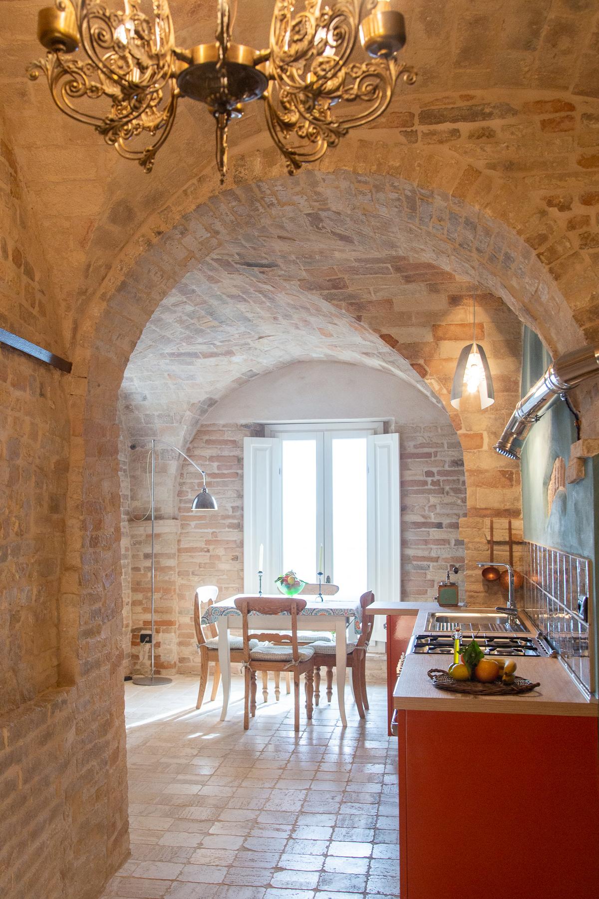 While the Palazzo Scarsini Apartment in Petritoli retains its 15th-century charm, the romantic one-bedroom is fully upgraded with modern appliances. (Courtesy of Appassionata)