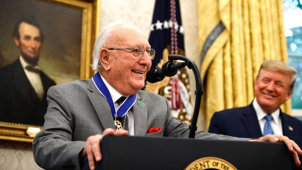 Former NBA basketball player and coach Bob Cousy, of the Boston Celtics, speaks as President Donald Trump smiles during a Presidential Medal of Freedom ceremony for Cousy, in the Oval Office of the White House, on Aug. 22, 2019. (Alex Brandon/AP Photo)