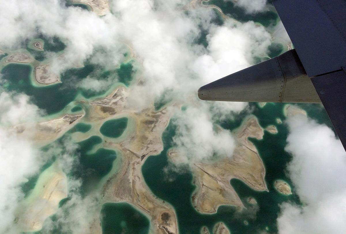Lagoons can be seen from a plane as it flies above Kiritimati Island, part of the Pacific Island nation of Kiribati, April 5, 2016. (Reuters/Lincoln Feast)