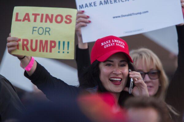 A woman holds a sign expressing Latino support for then-Republican presidential candidate Donald Trump at his campaign rally at the Orange County Fair and Event Center in Costa Mesa, Calif., on April 28, 2016. (David McNew/AFP/Getty Images)