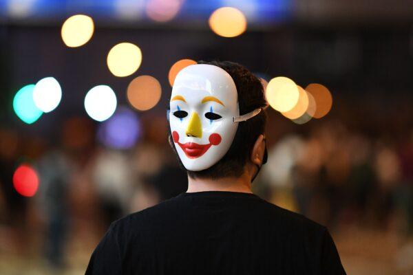 A man wearing a mask on the back of his head joins protesters gathered in the street in the heart of Hong Kong's commercial district Central on Oct. 4, 2019. (Mohd Rasfan/AFP via Getty Images)