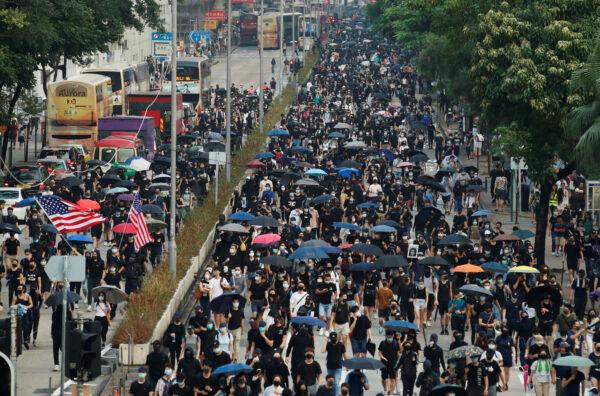 Pro-democracy demonstrators march in protest against a ban on face masks made under emergency laws in Hong Kong, China, Oct. 12, 2019. (Reuters/Umit Bektas)