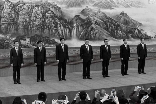 The Chinese Communist Party's Politburo Standing Committee, the nation's top decision-making body (L–R): Han Zheng, Wang Huning, Li Zhanshu, Chinese leader Xi Jinping, Premier Li Keqiang, Wang Yang, and Zhao Leji meet the press at the Great Hall of the People in Beijing on Oct. 25, 2017. (Wang Zhao/AFP via Getty Images)