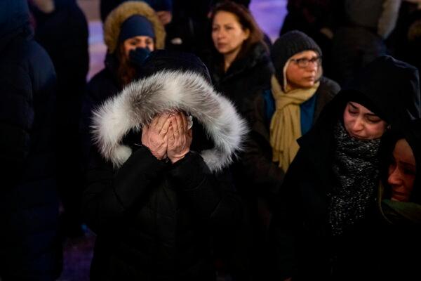 A woman mourns outside the Alberta Legislature Building in Edmonton, Alberta, during a vigil for those killed after a Ukrainian passenger jet crashed on Jan. 8, 2020. (Codie McLachlan/The Canadian Press via AP)
