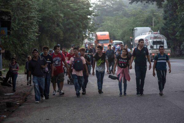 Hondurans walk along a road as they take part in a new caravan of migrants, set to head to the United States, in San Pedro Sula, Honduras, on Jan. 15, 2020. (Stringer/Reuters)