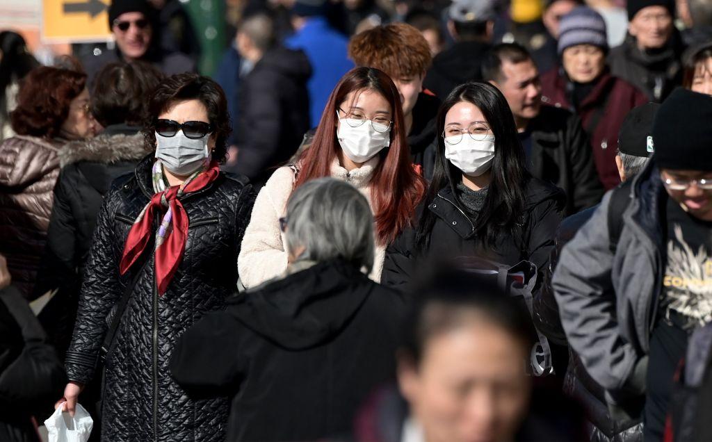 People wear surgical masks in fear of the coronavirus in Flushing, a neighborhood in the New York City borough of Queens on Feb. 3, 2020. (Johannes Eisele/AFP via Getty Images)
