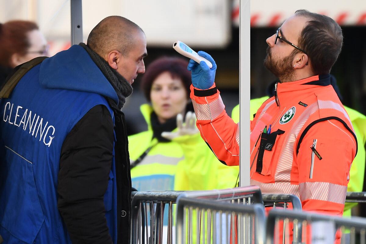 A health staff checks the body temperature of cleaning staff arriving at the Juventus stadium before a soccer match in Turin, Italy, on March 8, 2020. (Vincenzo Pinto/AFP/Getty Images)