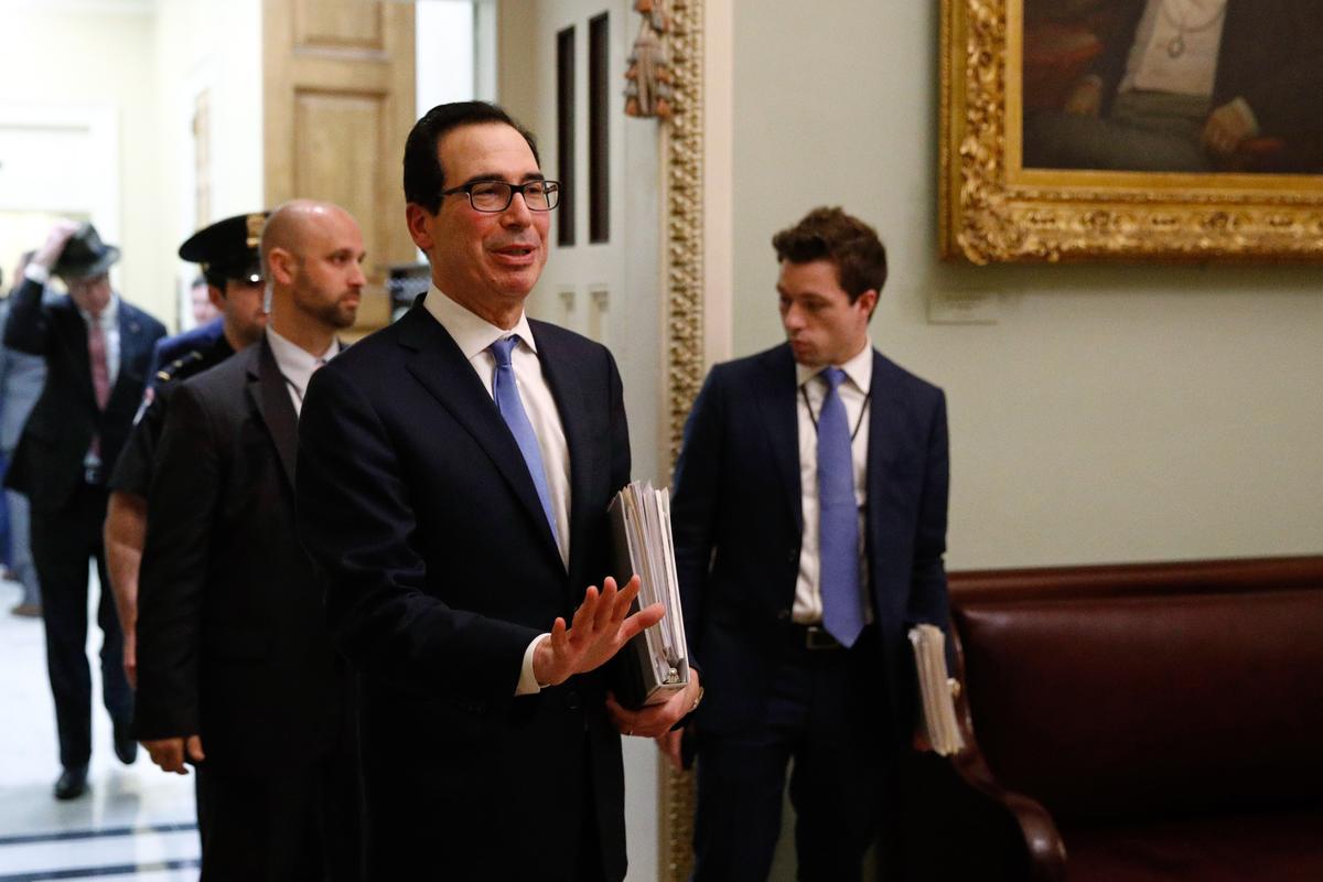 Treasury Secretary Steve Mnuchin asks members of the media to practice social distancing as he departs a meeting on Capitol Hill in Washington on March 16, 2020. (AP Photo/Patrick Semansky)