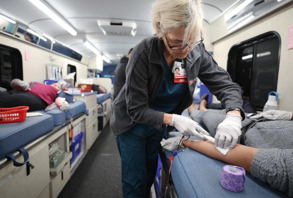 Cedars-Sinai charge nurse Lorraine McPherson works as employees donate blood during a blood drive held in a blood mobile outside Cedars-Sinai Medical Center in Los Angeles, Calif., on March 19, 2020. (Mario Tama/Getty Images)