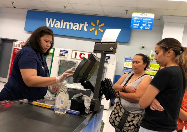 Customers look on as a Walmart cashier rings up their purchases at a Walmart store in California in a file photograph. (Justin Sullivan/Getty Images)
