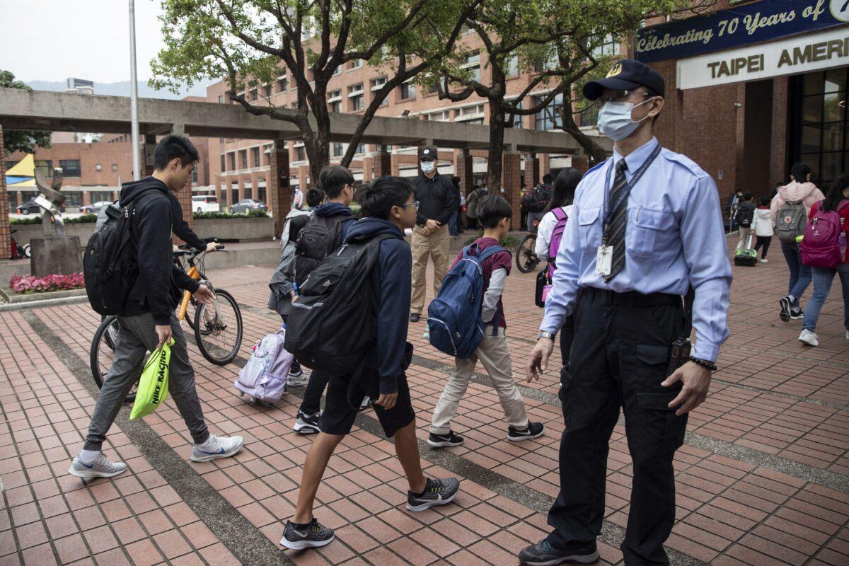 Students enter the Taipei American School in Taipei on March 18, 2020. (Paula Bronstein/Getty Images)