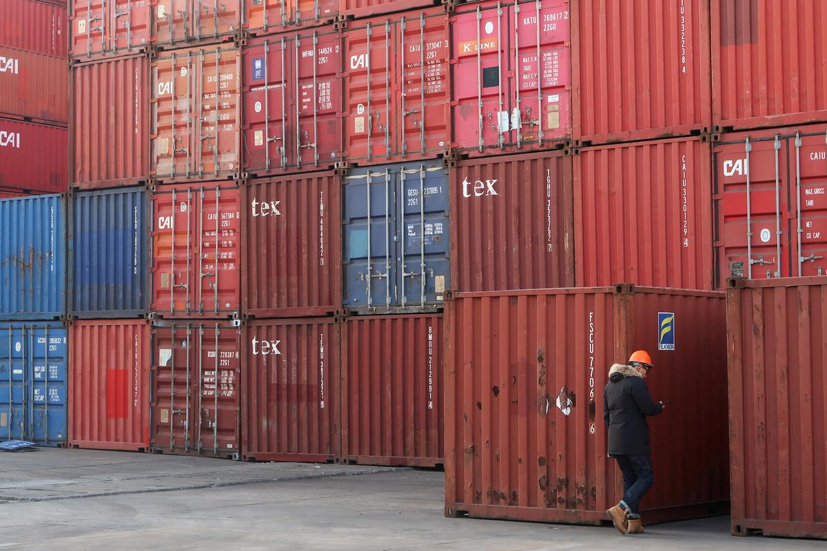 A worker checks containers at a logistics center near Tianjin port, in Tianjin, China, on Dec. 12, 2019. (Yilei Sun/Reuters)