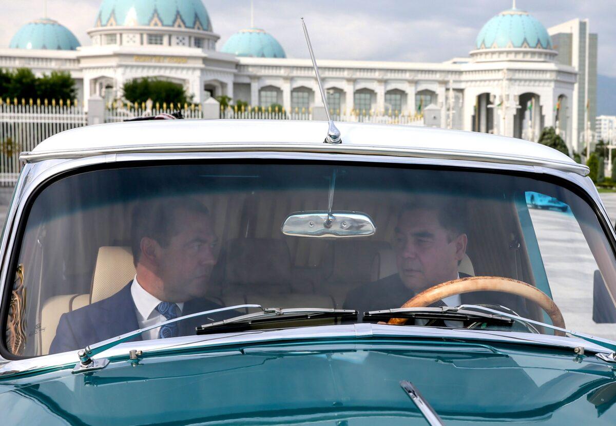 Turkmen President Gurbanguly Berdymukhamedov and Russian Prime Minister Dmitry Medvedev ride in a Volga car during a meeting in Ashgabat, Turkmenistan, on May 31, 2019. (Yekaterina Shtukina/AFP/Getty Images)