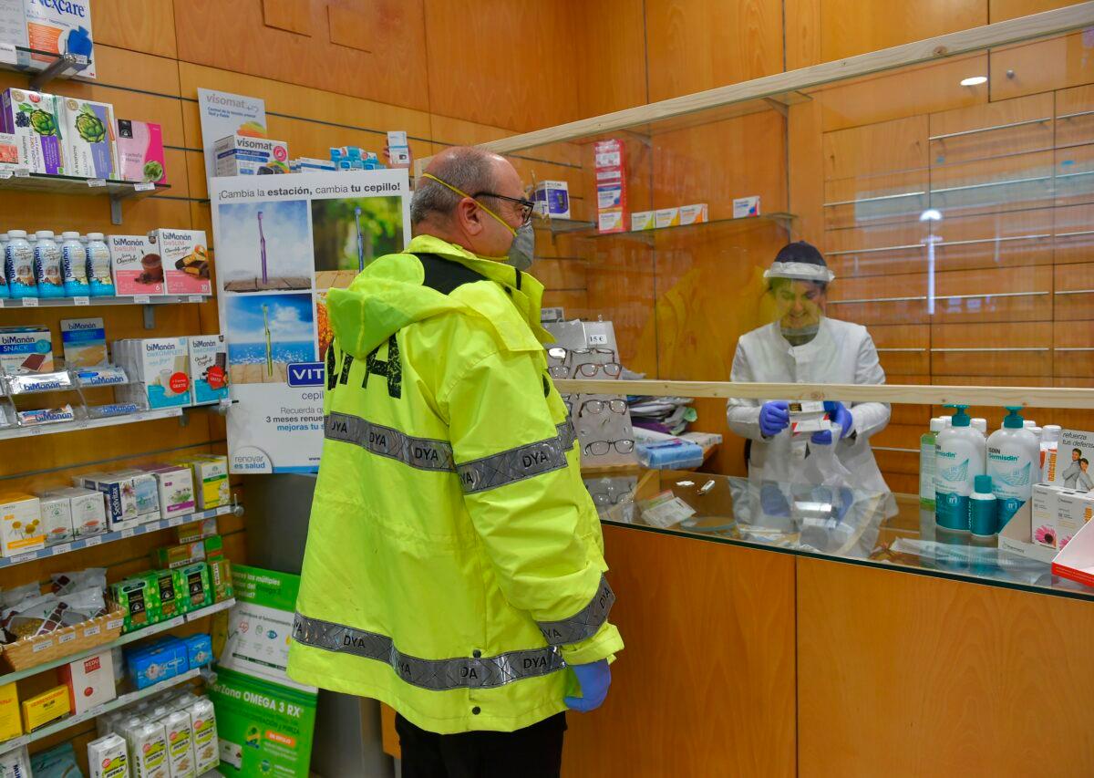 A volunteer of the nonprofit organization DYA collects medecine at a pharmacy for people who can not leave their homes in the Basque Spanish city of San Sebastian on April 1, 2020. (Ander Gillenea/AFP via Getty Images)