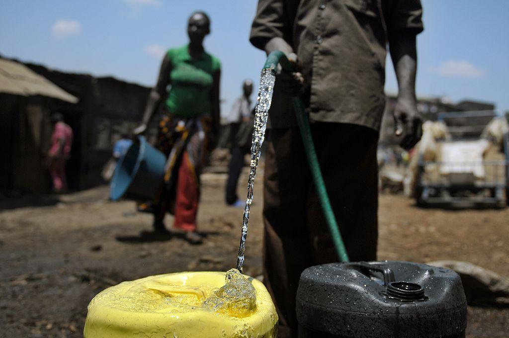 A water-vendor collects water in jerrycans to sell in the Mathare slum, Nairobi, Kenya, on March 22, 2012, where a water shortage continues to bite on World Water Day. (Tony Karumba/AFP via Getty Images)